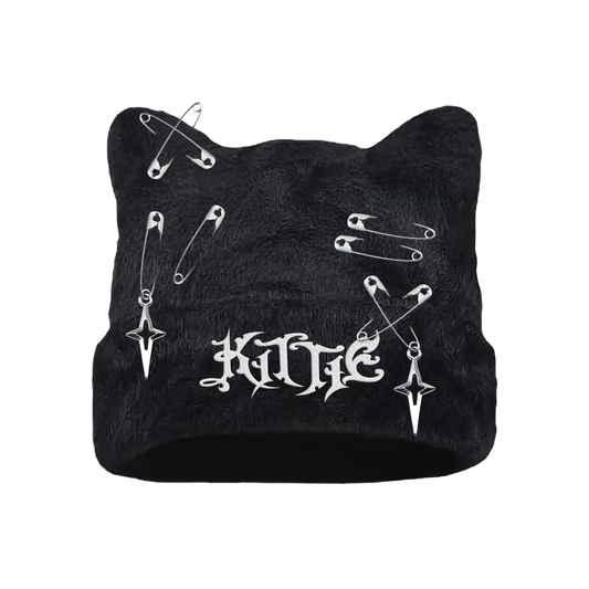 The Kittie Logo - Custom Cat Ears Beanie is a black winter hat with cat ears, safety pins, two cross earrings, and a white gothic embroidered KITTIE logo—perfect for making a bold statement.